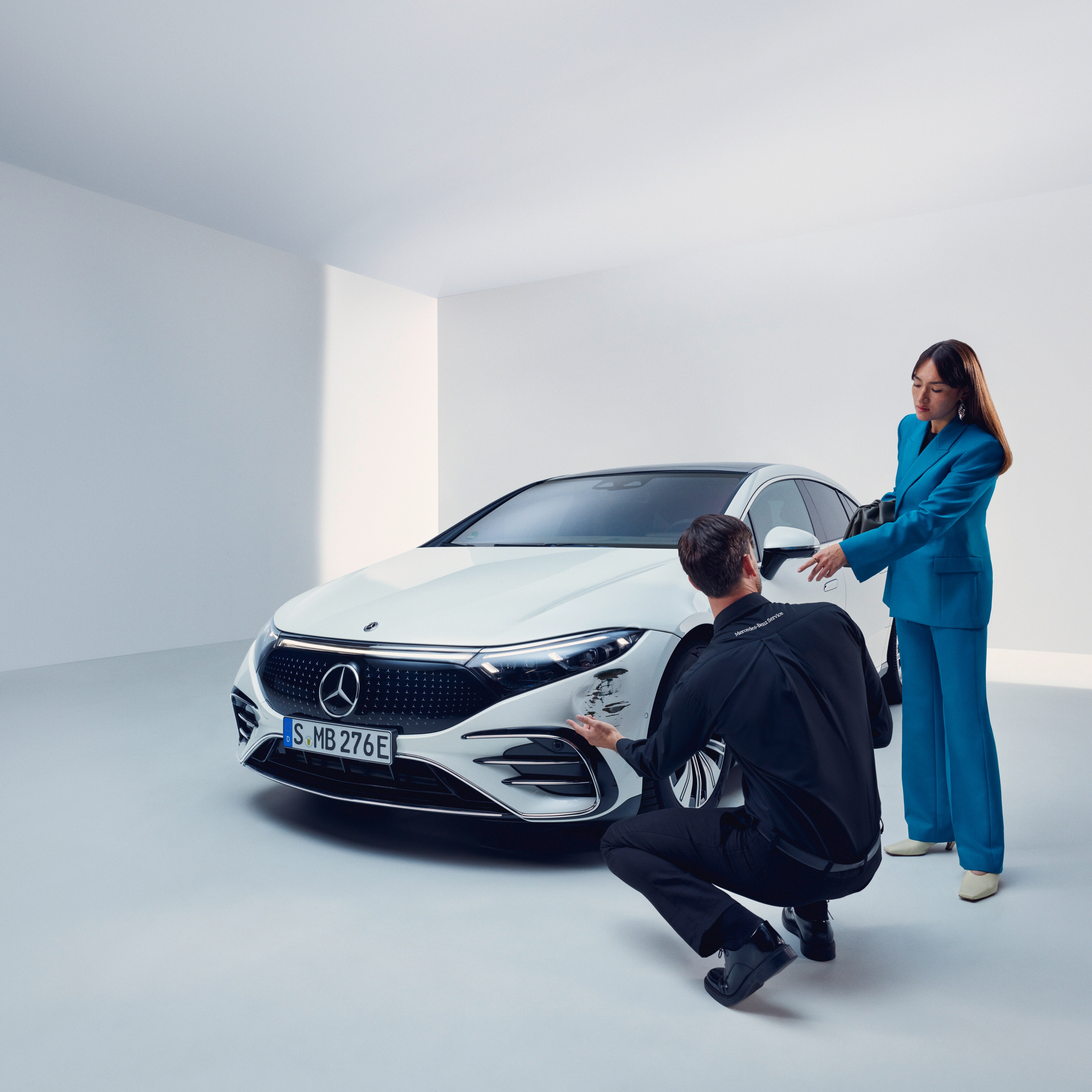A man inspecting a womans Mercedes-Benz.