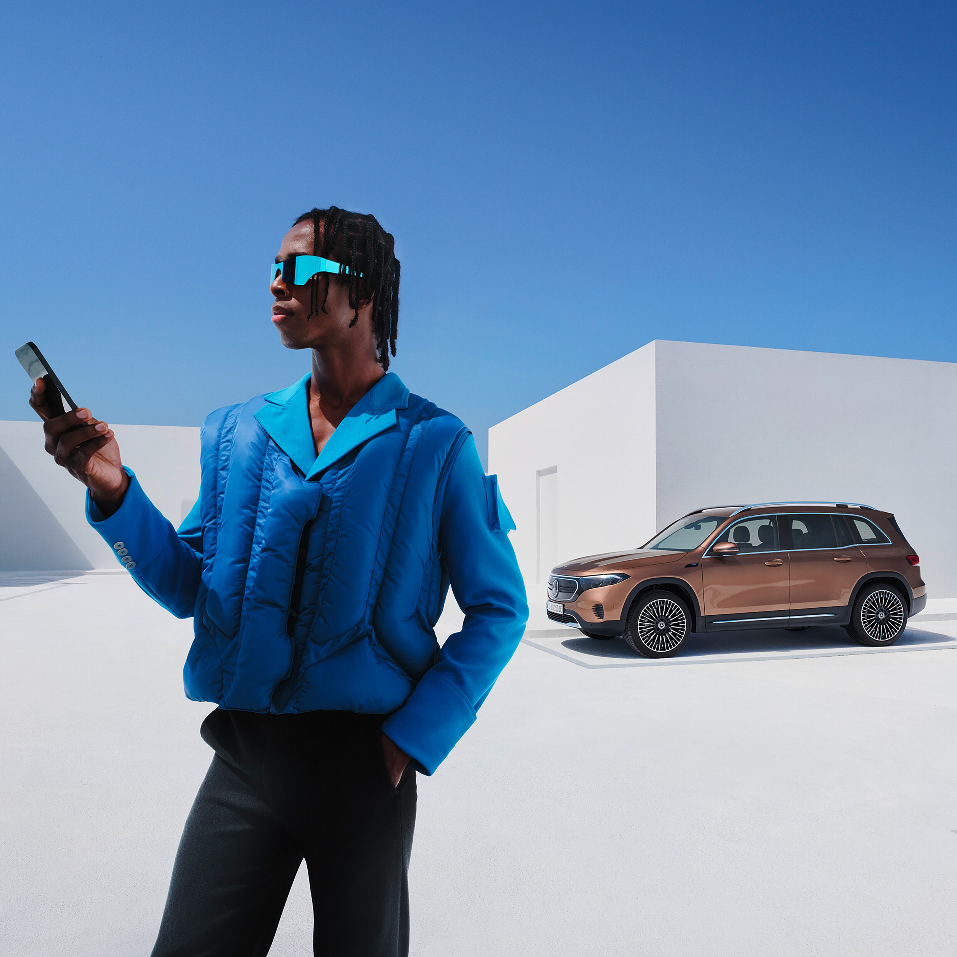A man in front of the EQB from Mercedes-Benz.