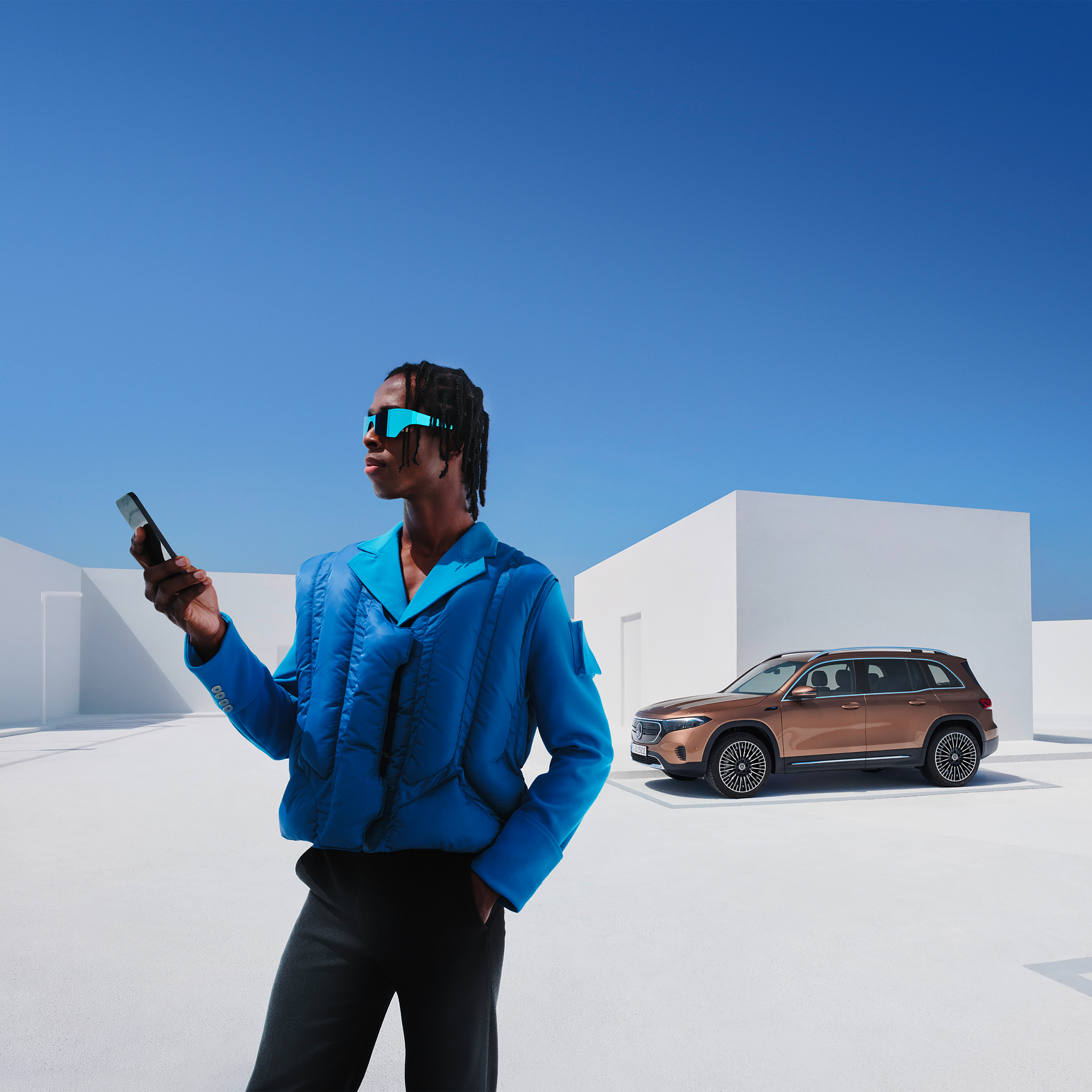 Remote | Mercedes me A man in front of the EQB from Mercedes-Benz.