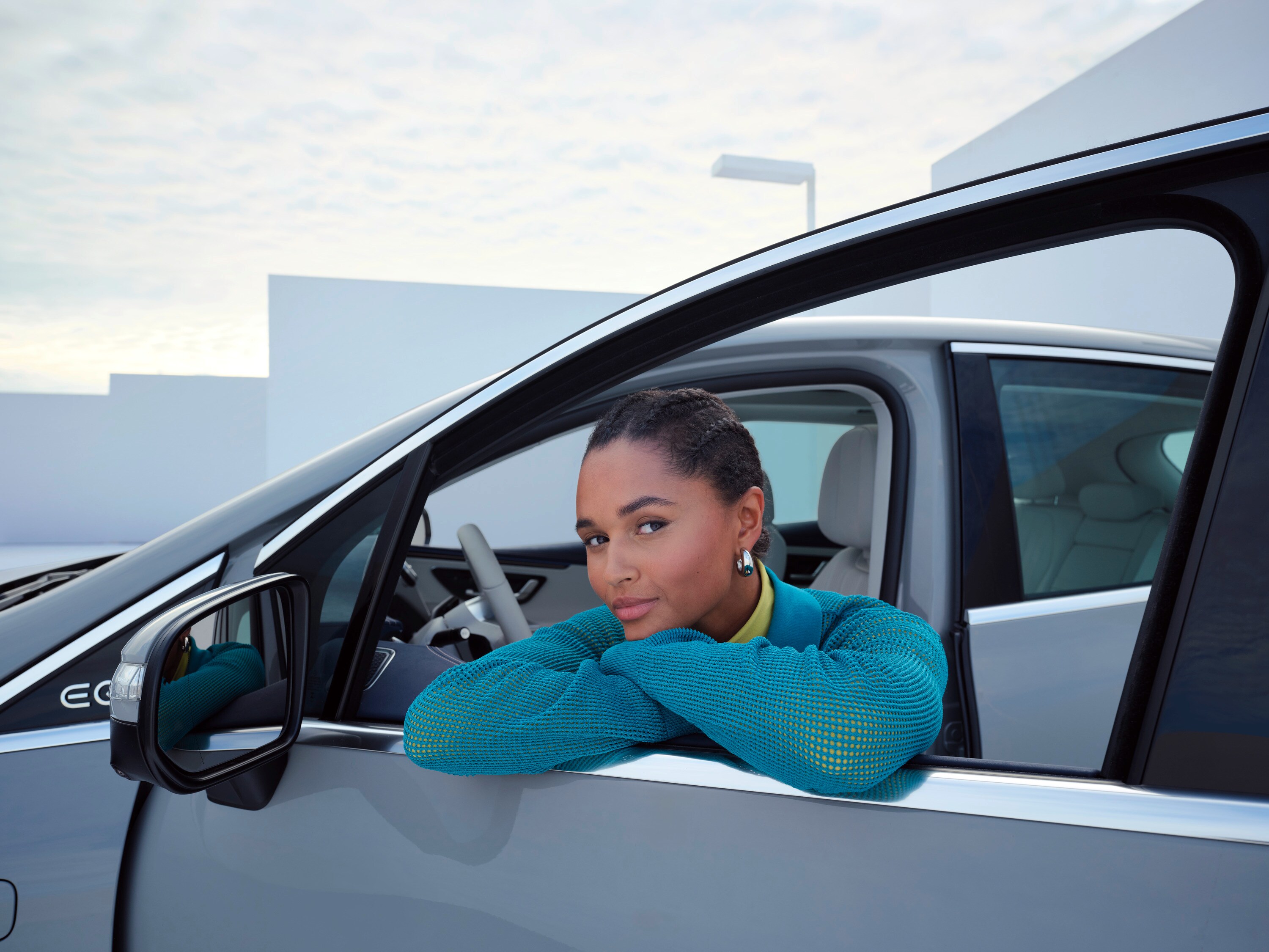 Woman leaning in window of her Mercedes-Benz 