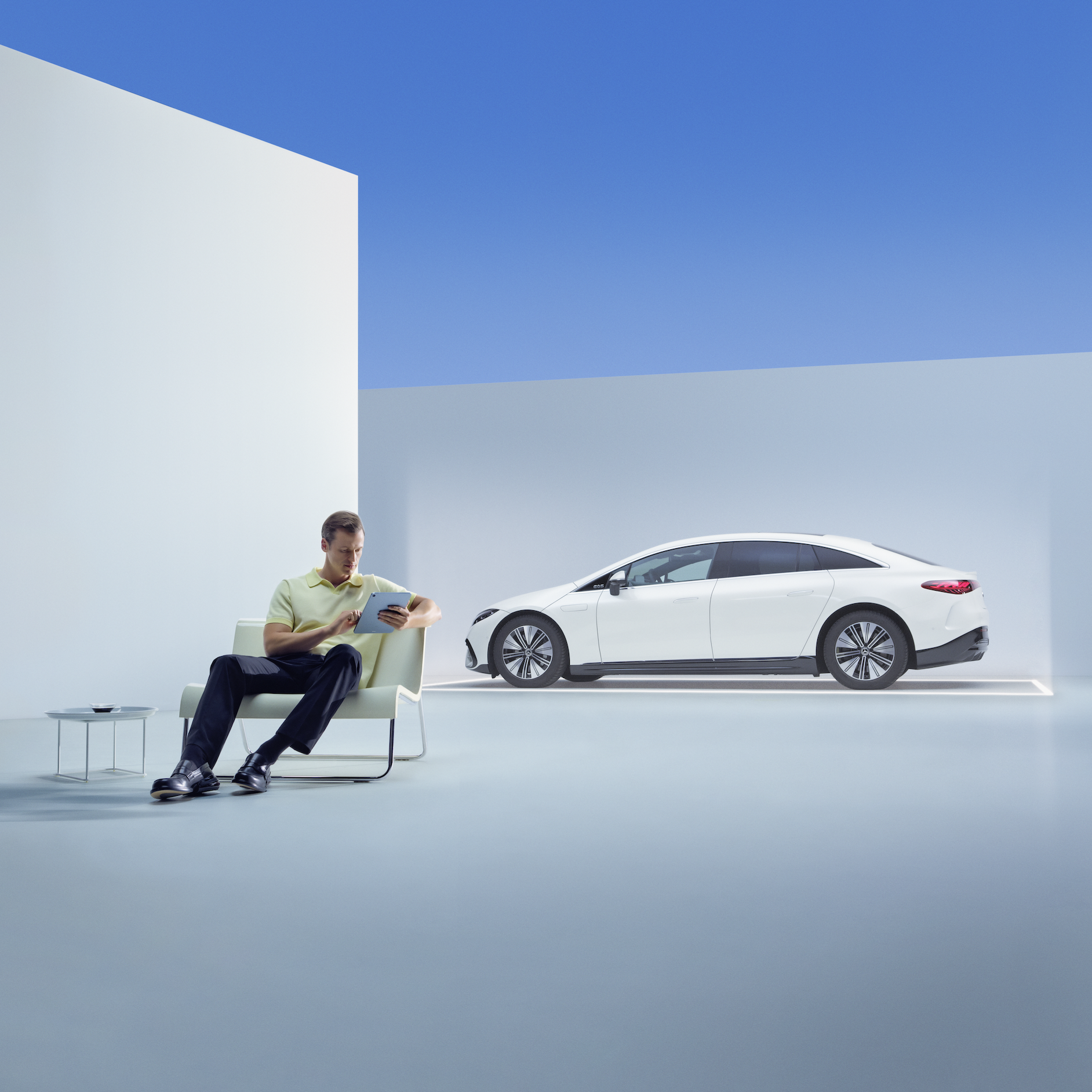 Have a safe journey with the Mercedes-Benz warranty for new vehicles. | Mercedes-Benz A relaxed man is sitting in front of his Mercedes with his tablet.