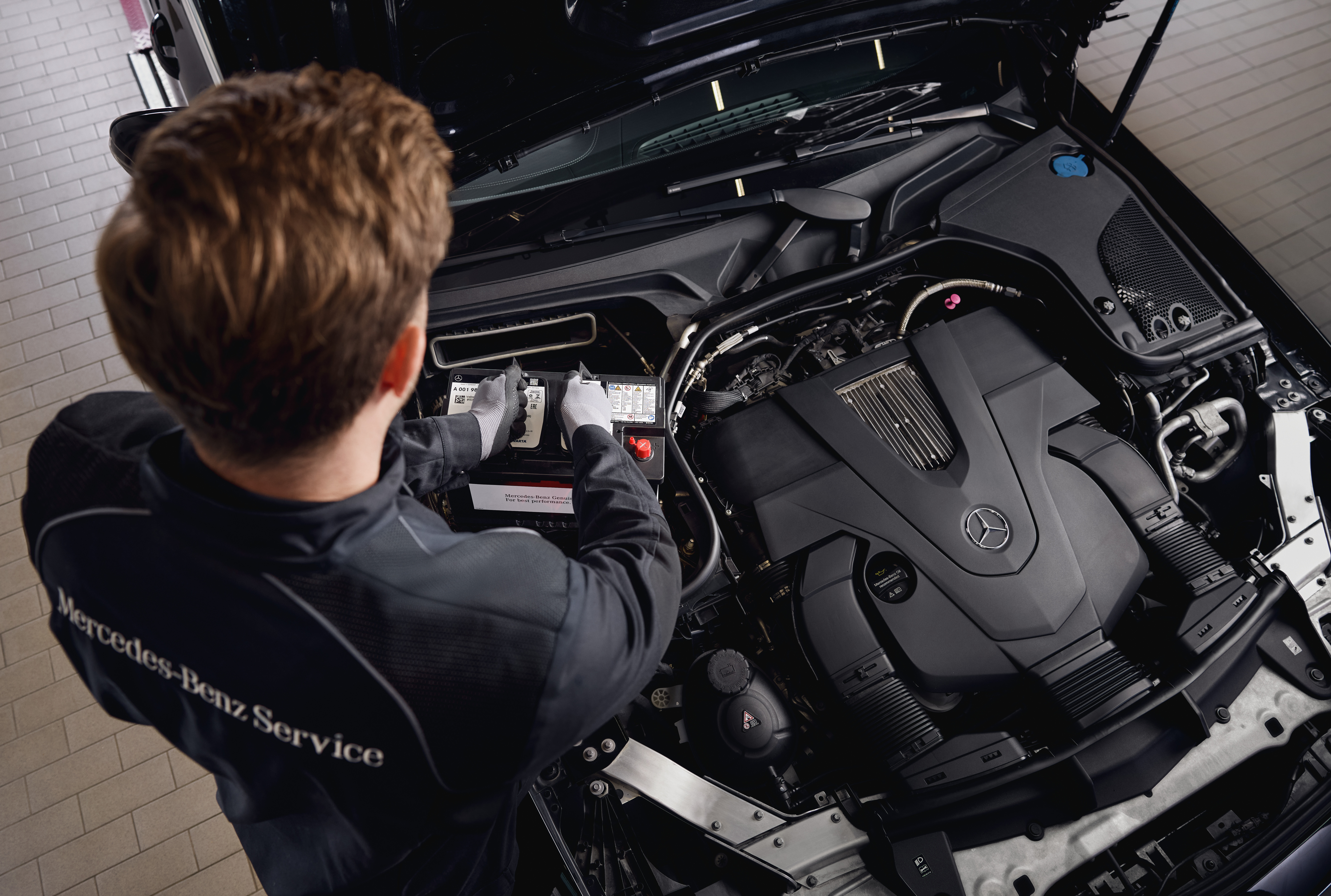 Mercedes-Benz Genuine Starter Batteries Engine service at a workshop, showing the replacement of components using genuine Mercedes‑Benz parts.