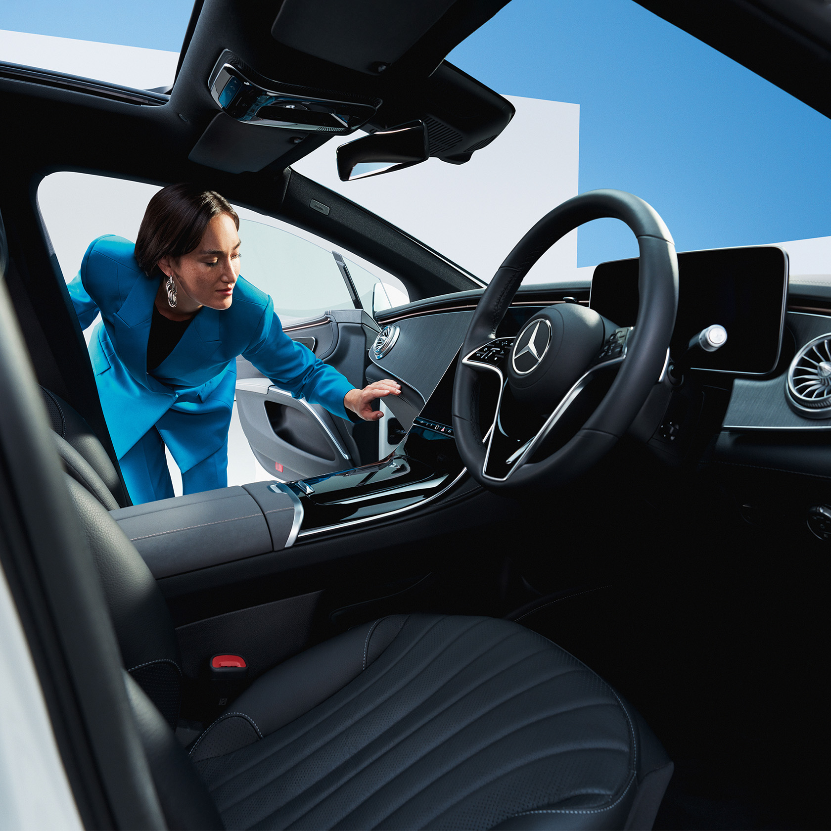 CompactandComprehensive Woman in a blue blazer looking inside the car