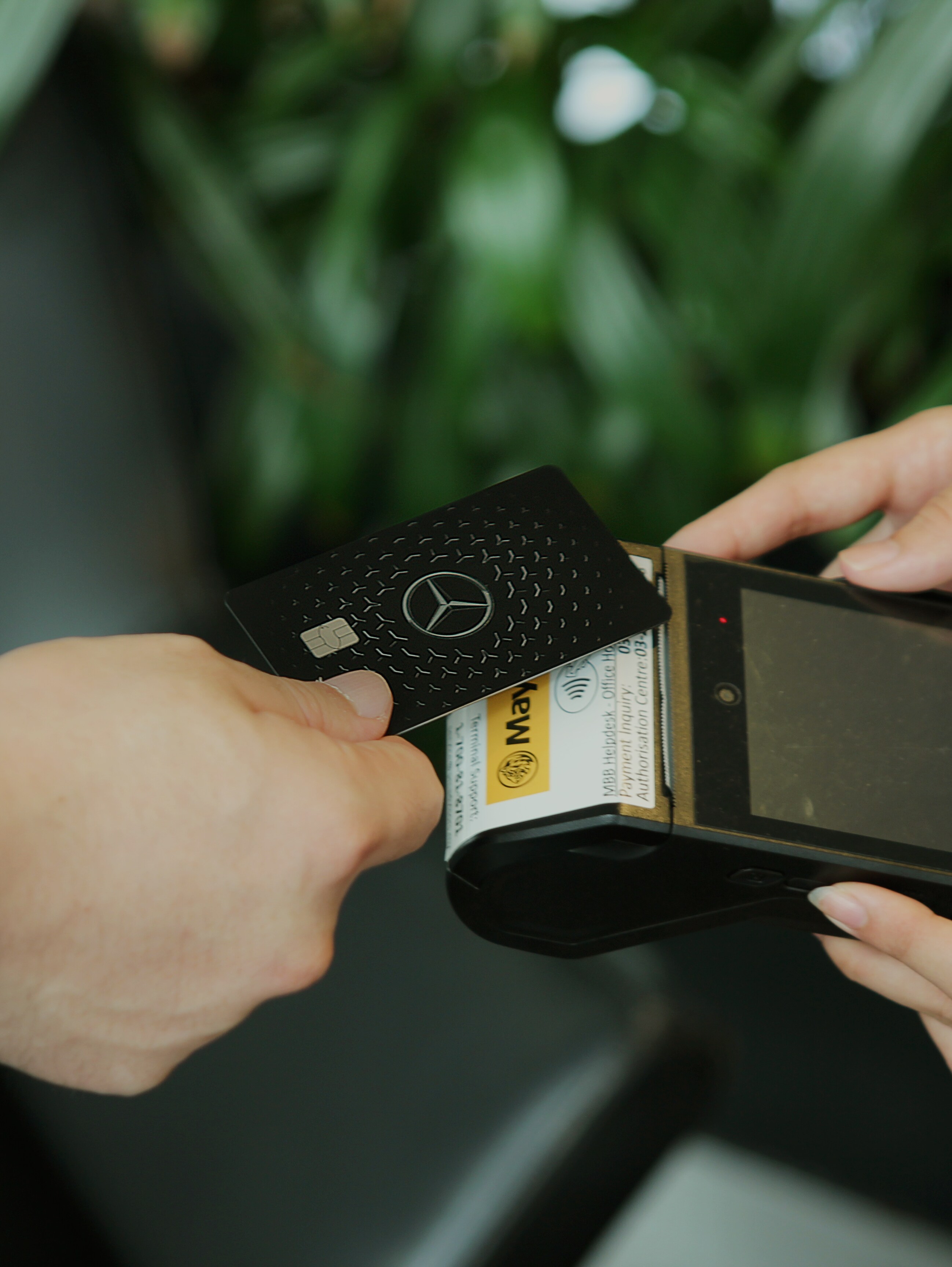 A man making a payment with a Mercedes-Benz Card 