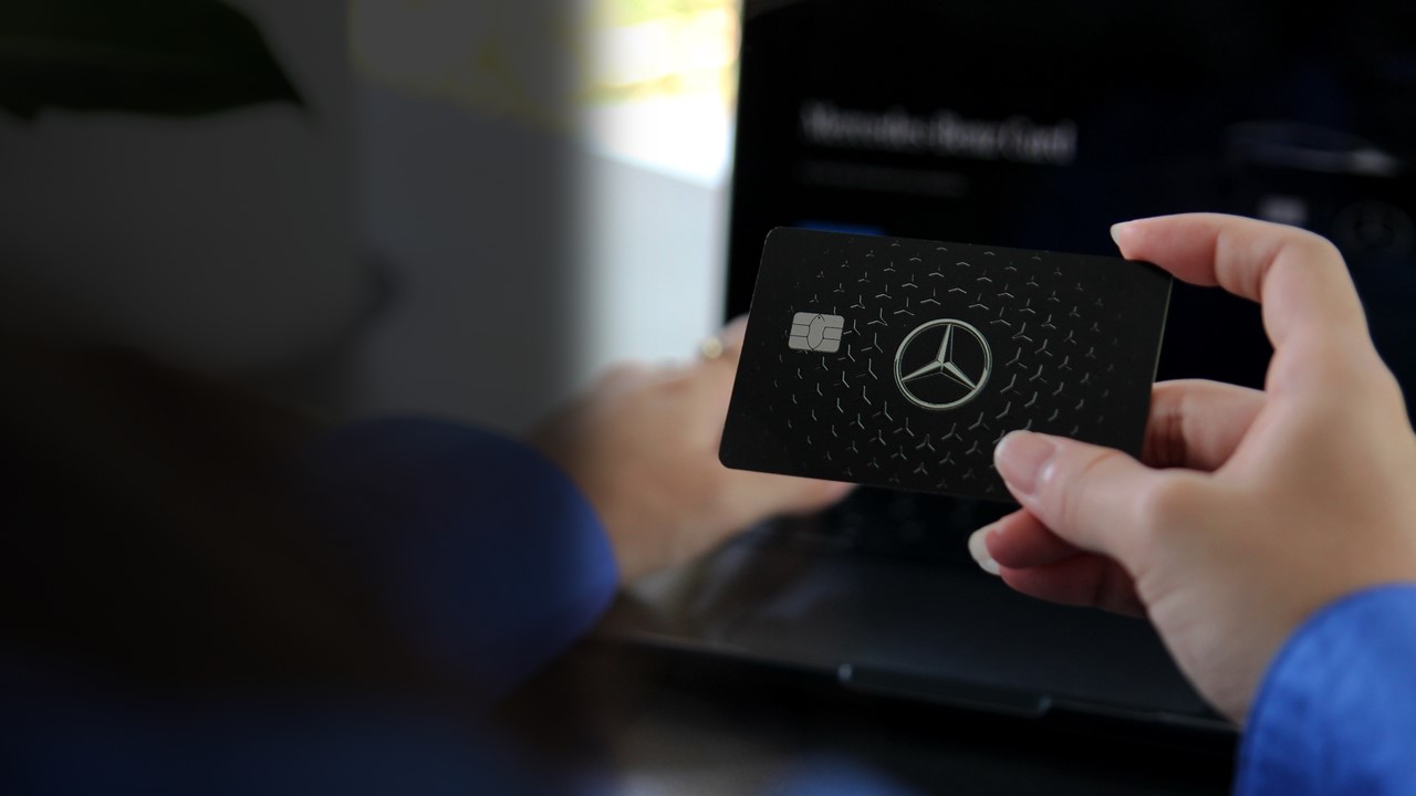 Mercedes-Benz card | Brand | Mercedes-Benz A woman holding a Mercedes-Benz Card