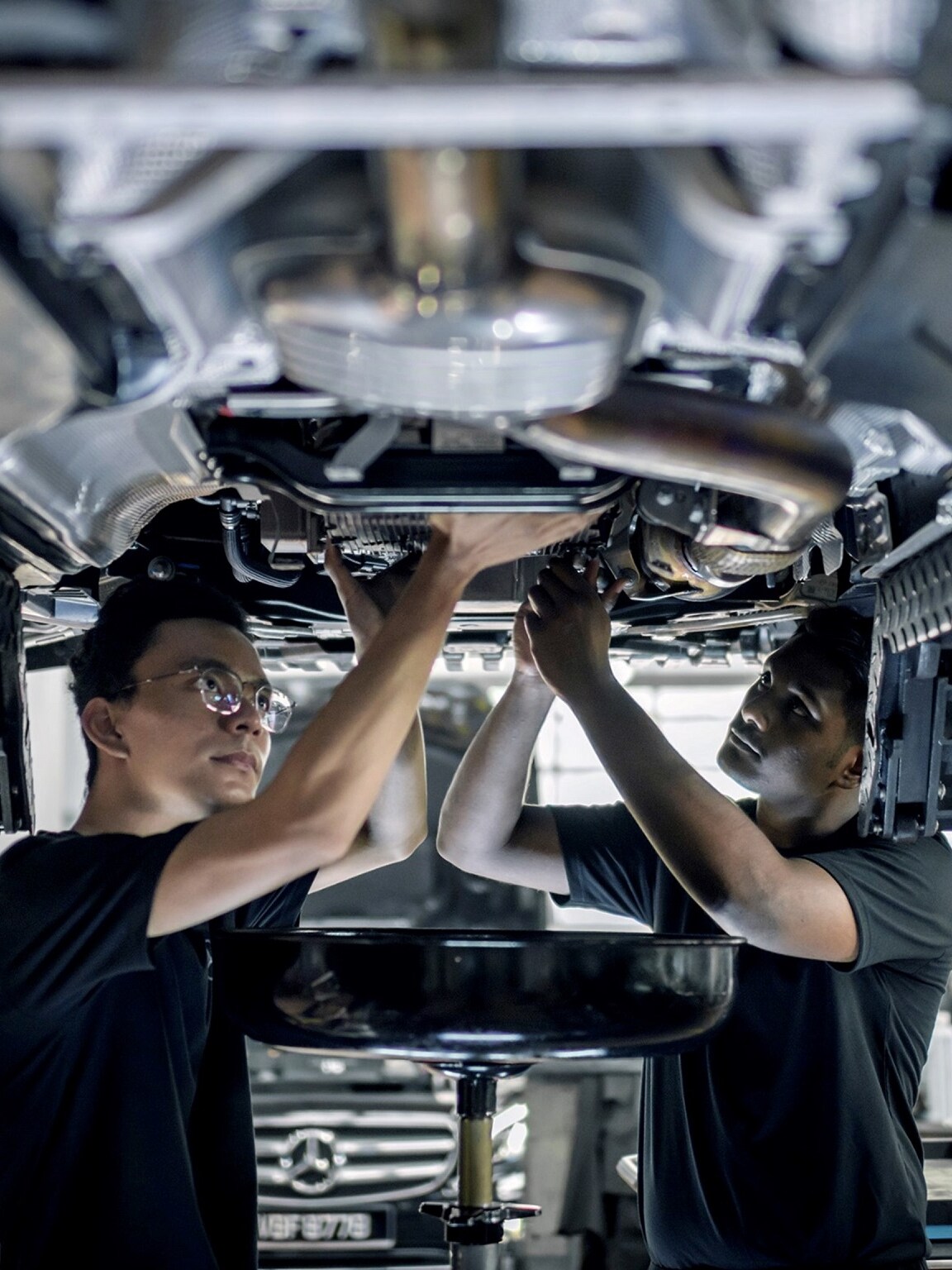 Two Mercedes-Benz Apprentices working on a vehicle